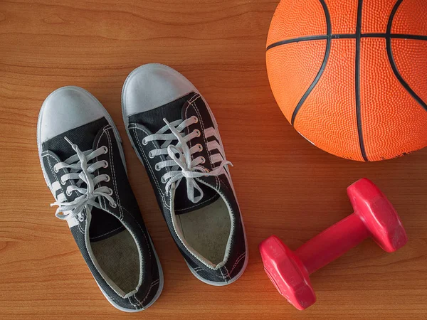 Sports shoe with a basketball and dumbbell.