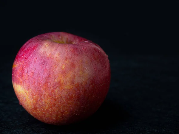 Apple fruit on black background.