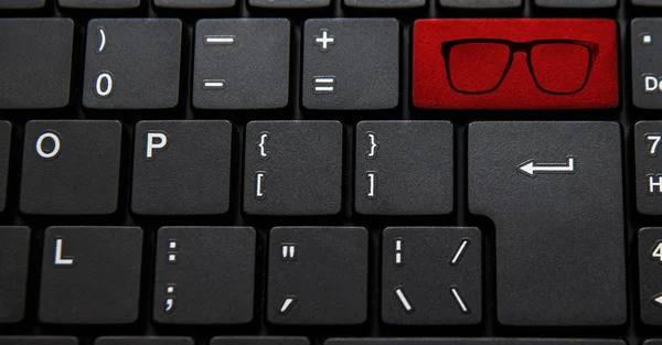 computer keyboard with glasses icon