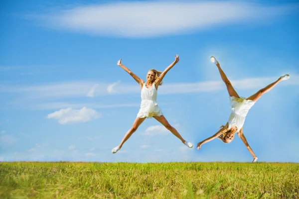 Mujer Jumping on a Grass Hill —  Fotos de Stock