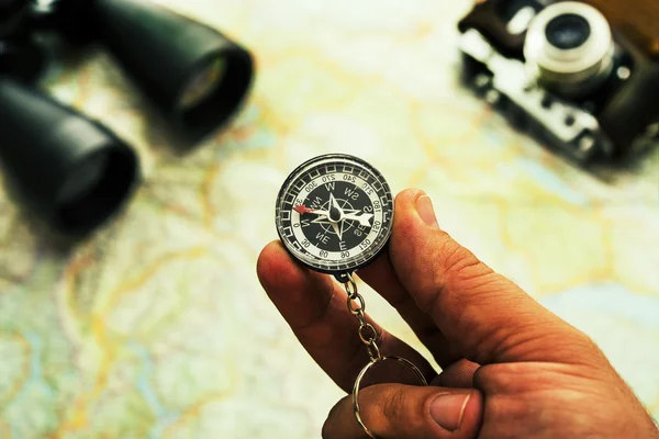 hand holding  trinket compass