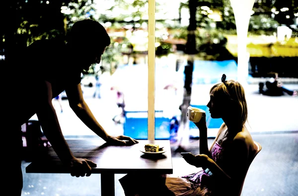 Couple dating inside cafe.