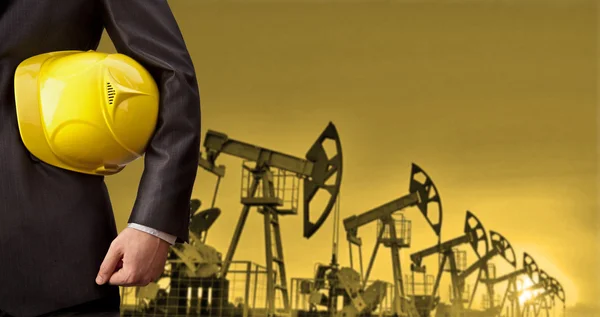 Oil worker  holding yellow helmet — Stock Photo, Image