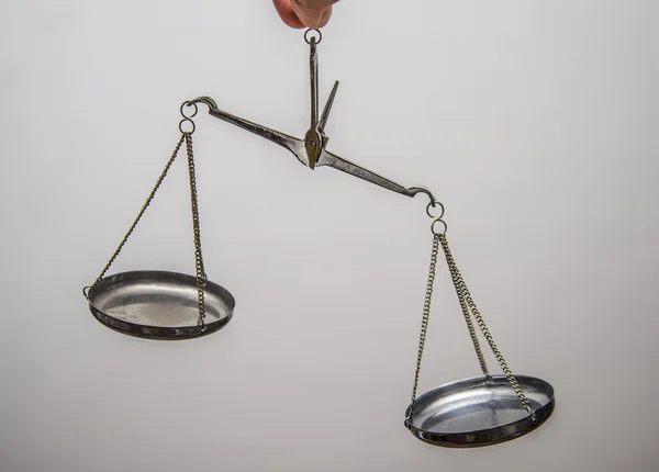 Hand holding empty scales of justice — Stock Photo, Image