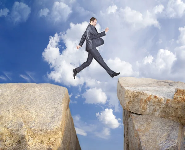 Full Length Businessman Jumping Rock Another — Stock Photo, Image