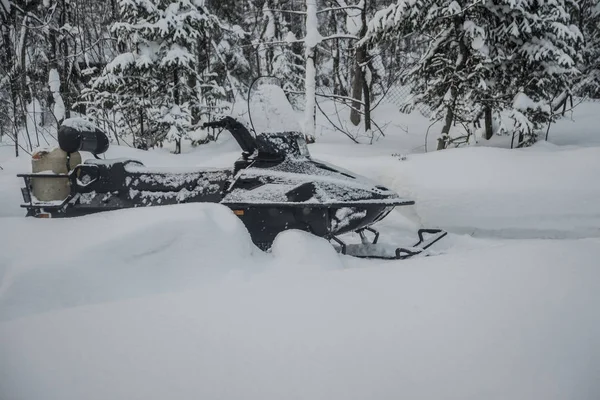 Snowmobile in snowy winter forest — Stock Photo, Image