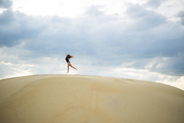 woman  jumping  up in desert