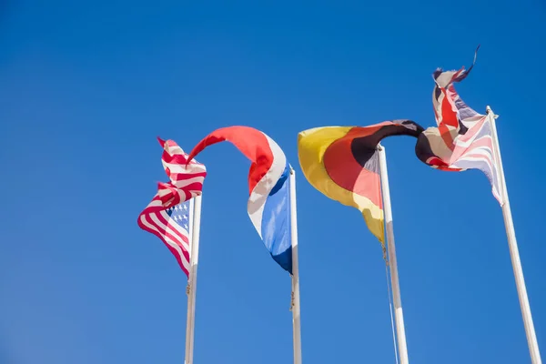 Flags against blue clear sky background — Stock Photo, Image