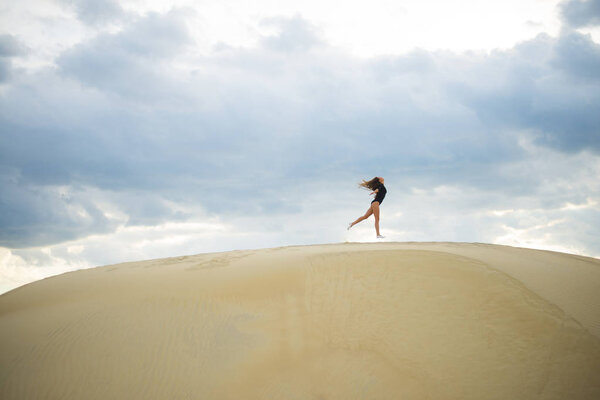 woman  jumping  up in desert