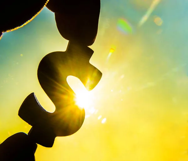 Hand holds  silhouette of dollar sign — Stock Photo, Image