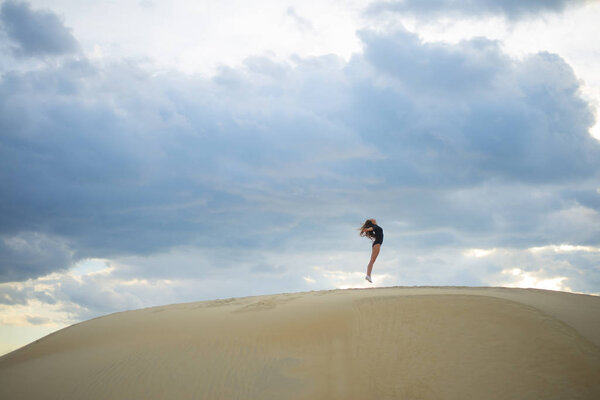 woman  jumping  up in desert