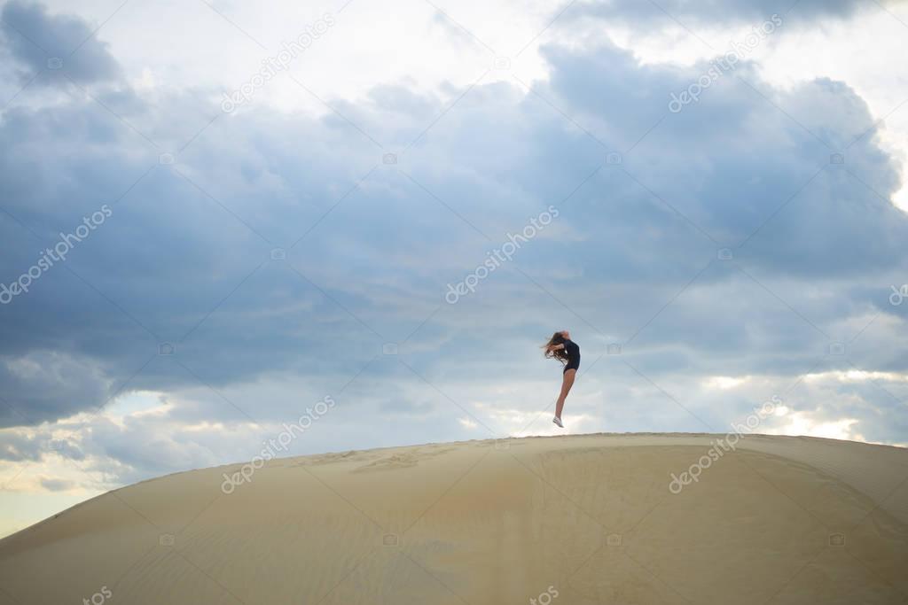 woman  jumping  up in desert