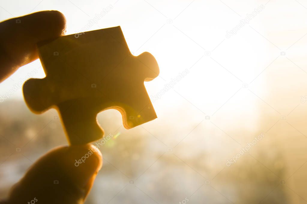 hand holding  puzzle piece 