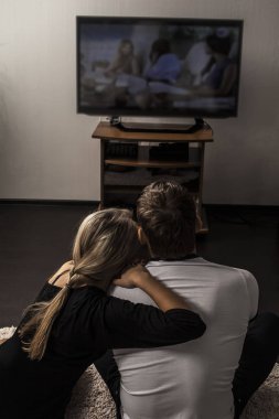  couple watching  tv set clipart