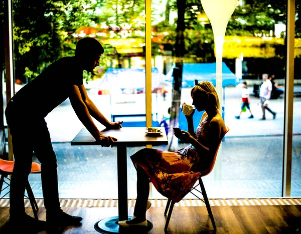 Couple Dating Cafe Silhouette Woman Drinking Coffee Using Mobile Phone — Stock Photo, Image