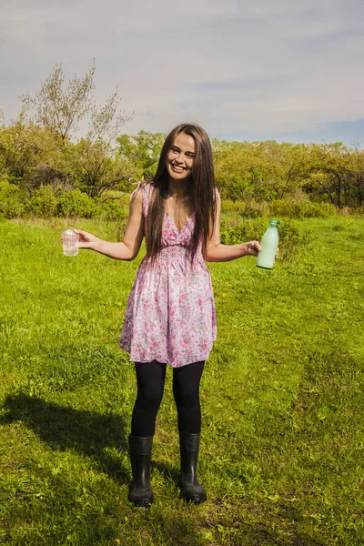 Дівчина тримає скляну пляшку і молоко — стокове фото