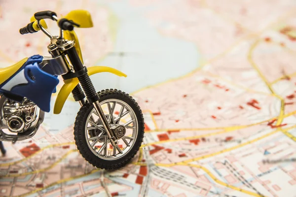enduro motorcycle toy on map.