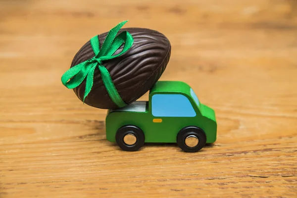 Easter egg on green toy car — Stock Photo, Image