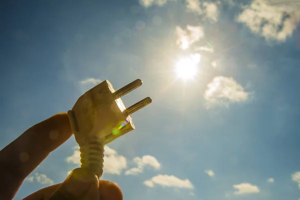 Hand holding a electrical socket — Stock Photo, Image