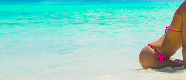  girl sitting on tropical beach