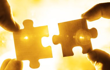 puzzle parçaları bağlanmaya çalışan eller 