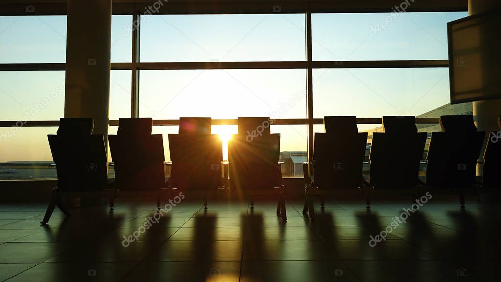 Seats, airport at sunset. 