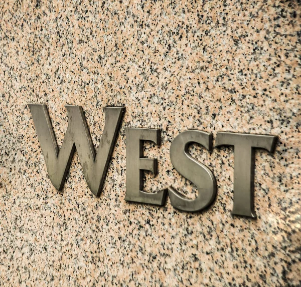 metal Sign on stone wall