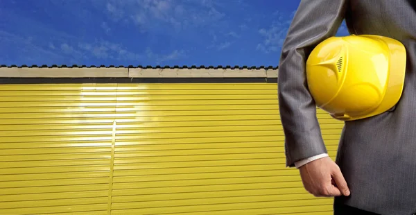 Torso of engineer  holding  helmet — Stock Photo, Image