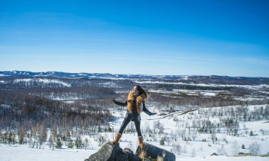 fox zencefil kürk yaka poz ile siyah montlu genç kadın. kış sezonu ve dağ manzara .