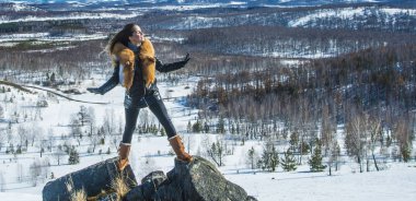 fox zencefil kürk yaka poz ile siyah montlu genç kadın. kış sezonu ve dağ manzara .