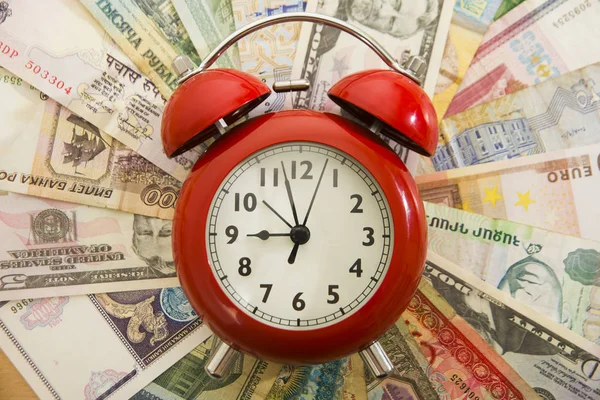 Alarm clock  on money bills