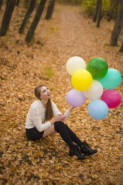 Jovem Mulher Sentada Nas Folhas Outono Com Balões Multicoloridos — Fotografia de Stock