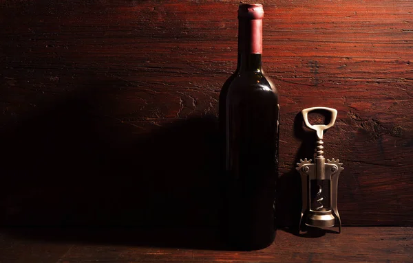 Wine bottle and metal corkcrew