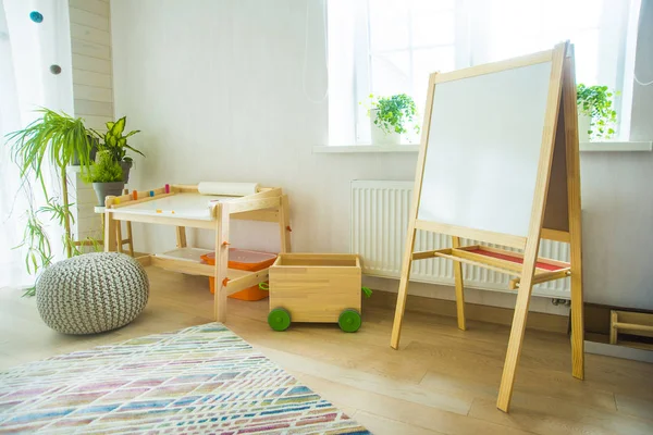 Kindergarten room with  furniture and natural green plants