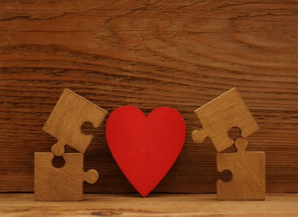 Puzzle pieces and  red heart — Stock Photo, Image