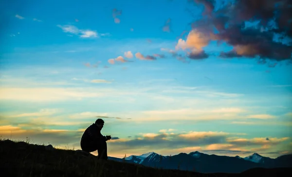 Man sitting  on the peak of rock