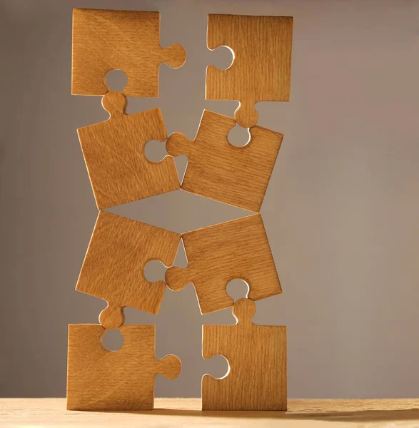 Pieces of puzzle  on wooden table — Stock Photo, Image