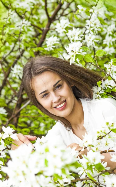 リンゴの木の花の新鮮な春の庭の美しい自然のブルネットのヒスパニック系女性の肖像画 — ストック写真