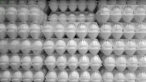 image of egg pallets in the truck. Plastic crates with fresh eggs stacks.