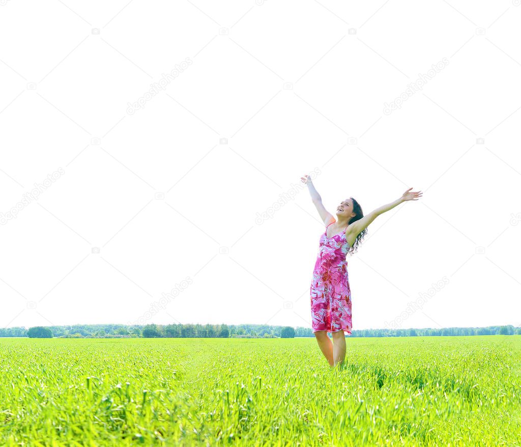 Young happy woman in green field with hands up. green grass field.