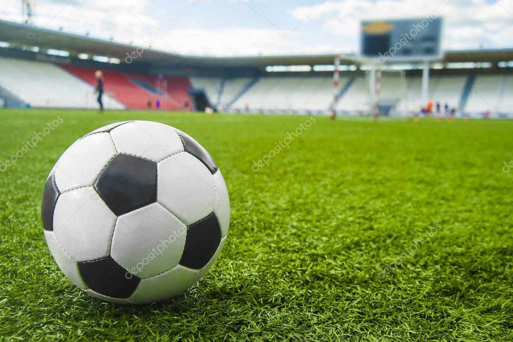 ball on green grass of stadium. Soccer ball  on  field background.