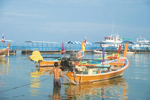 Colorful Thailand fishing boats on a sea shore.
