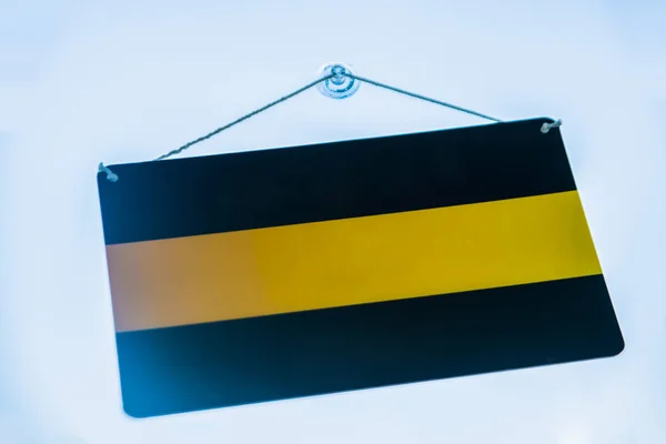 Empty Black Yellow Signboard Hanging Sucker Glass Door Blue Sky — Stock Photo, Image