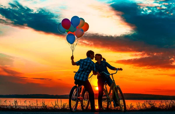 Silhouettes Two Beautiful Adult People Sitting Bicycles Girl Holding Colorful — Stock Photo, Image