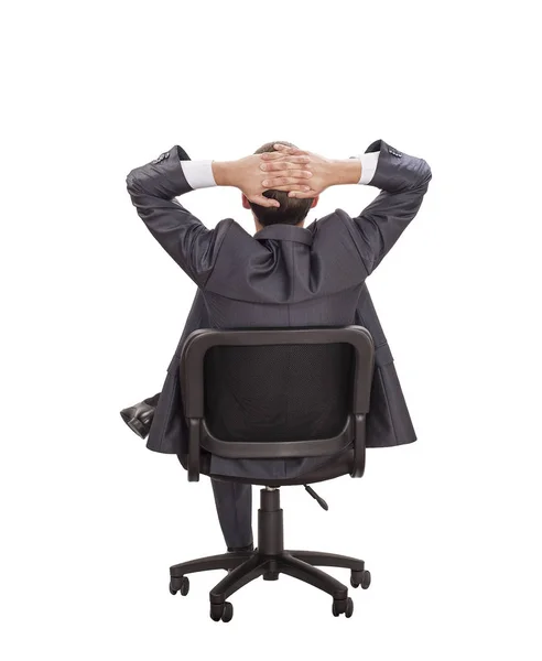 白い壁に椅子に座っている夢のビジネスマンをリラックス — ストック写真