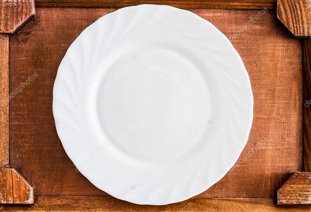 empty White ceramic dish, plate on the wooden tray - food background. Top view. wood table 