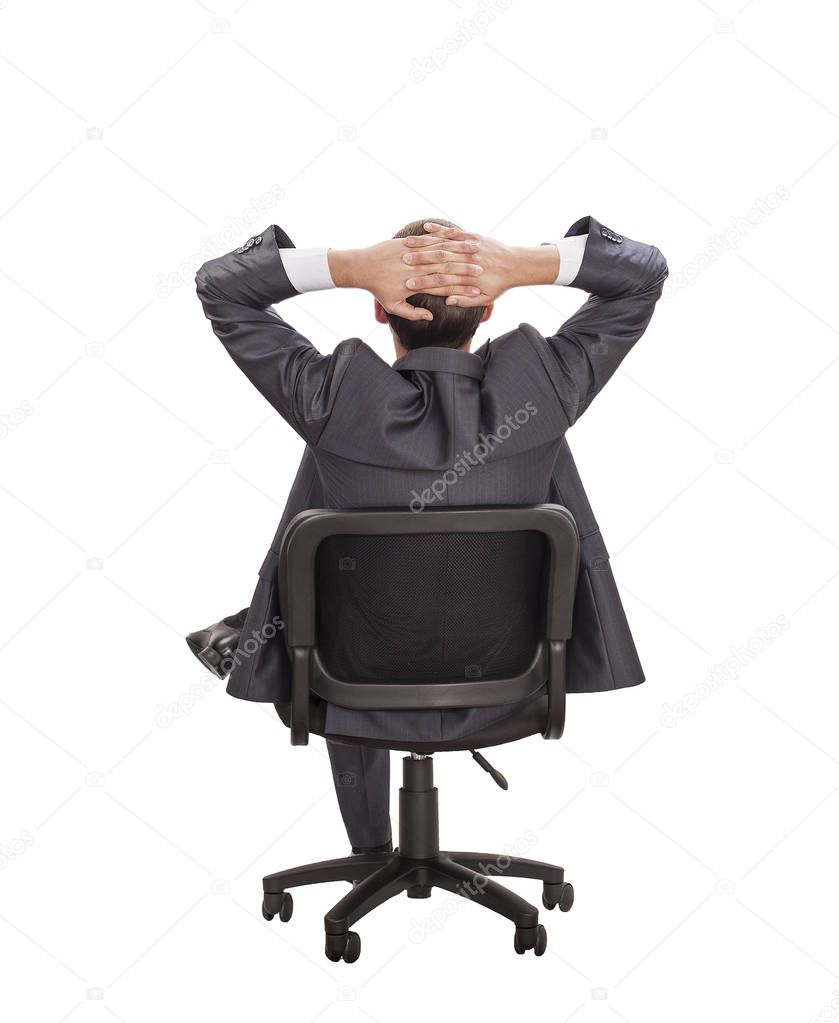 relaxing dreaming businessman sitting in chair  against white wall