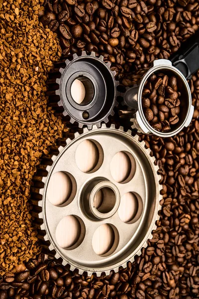 Iron Gear over wooden background against view coffee beans and i — стоковое фото