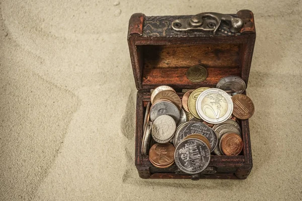 treasure chest with euro money on  sand background.
