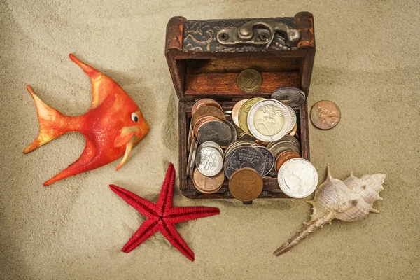 Treasure chest in underwater background. huge treasure chest on the bottom of the sea. red sea star on sand background.